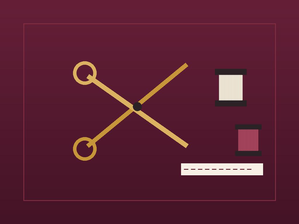 Tailoring shears, thread spools and chalk arranged on folded cloth